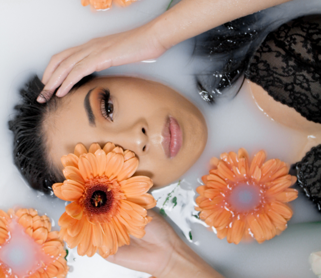 woman with flower in milk bath