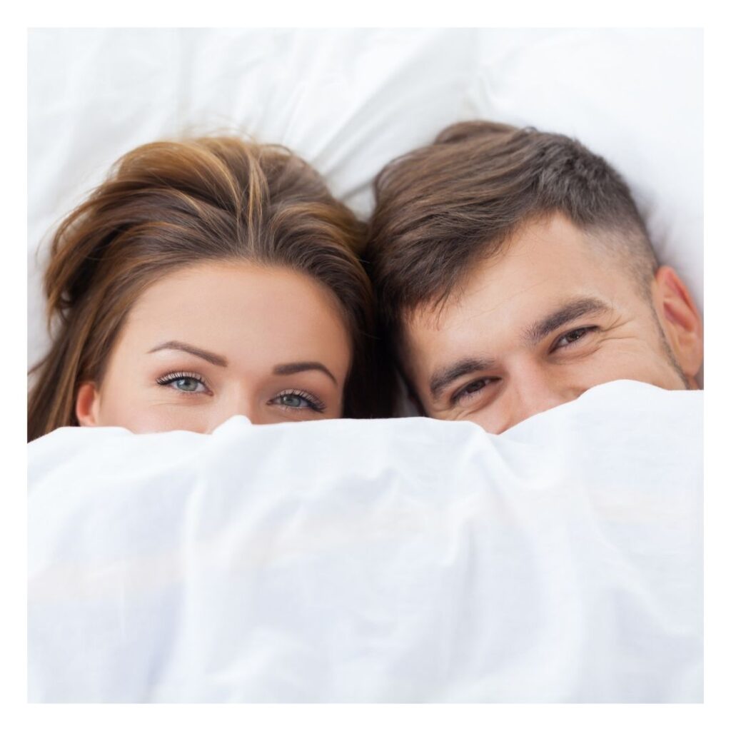 couple laying under the covers together